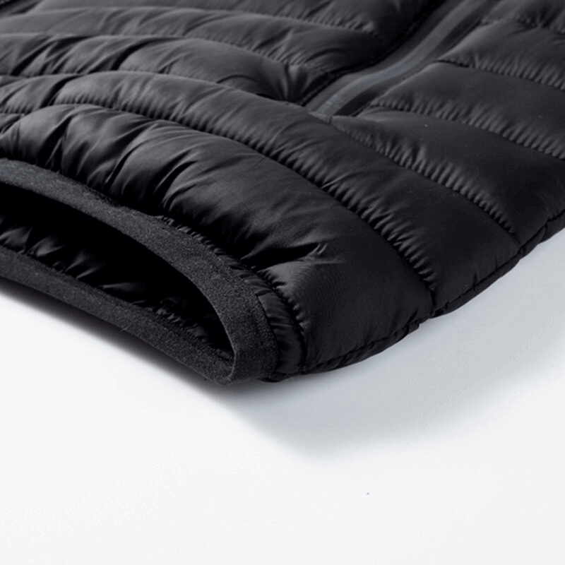 Close-up of black nylon fabric on men's vest with zippered pocket, ideal for outdoor sports and casual wear.